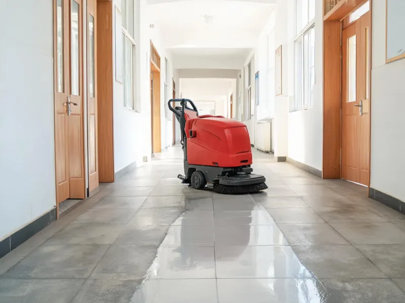 Walk-behind floor scrubber on a narrow corridor route